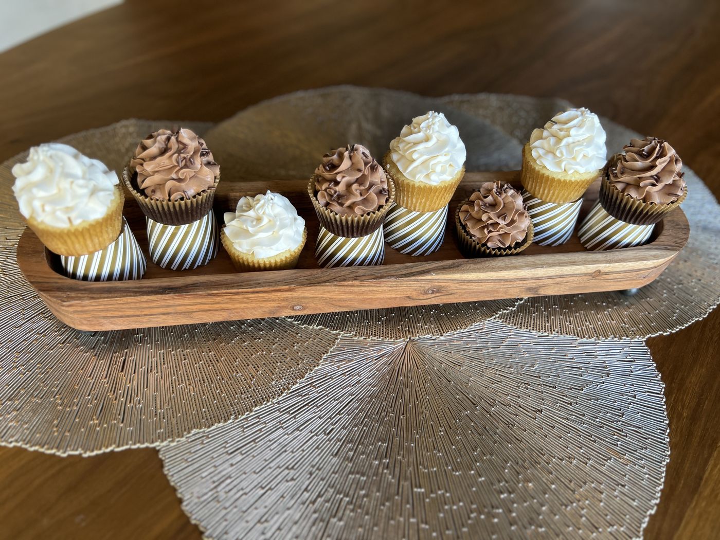 Cupcakes lined up in a wooden display tray